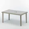 A rectangular outdoor dining table with a woven rattan base and a glass top, shown against a white background. Anteprima dell’immagine prodotto