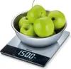 A digital kitchen scale with a bowl of green apples on top. Produktbild-Vorschau
