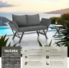 A rattan sofa is placed on a patio next to a swimming pool with a view of the sea and mountains. Produktbild-Vorschau