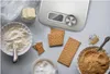 A top-down view of baking ingredients and a kitchen scale. Anteprima dell’immagine prodotto