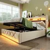 A bedroom scene with a bed that has its storage compartment open, revealing the hydraulic lift mechanism. The bed is made up with a green blanket. Náhled obrázku produktu