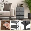A collage of images showing details of a gray fabric dresser with a metal frame, placed next to a sofa and a plant. The collage also includes close-ups of the dresser's features and a hand wiping a wooden surface. Podgląd zdjęcia produktu