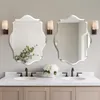 A bathroom vanity with two mirrors, sinks, and faucets. Anteprima dell’immagine prodotto