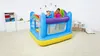 Two young girls are playing inside a colorful inflatable bounce house in a room. Voir les images du produit