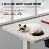 A cat is sleeping on a white desk in front of a window. Text overlays describe the desk's quiet adjustment feature. Podgląd zdjęcia produktu