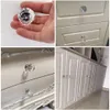 A collage of four images showing crystal cabinet knobs and handles on white furniture. Produktbild-Vorschau