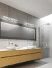 A modern bathroom with a double vanity, large mirror, and shower. Podgląd zdjęcia produktu