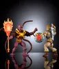 Two action figures, He-Man and Vecna, in a dynamic pose as if in combat, with reflections on a dark surface. Produktbild-Vorschau