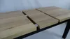 A close-up, angled view of a wooden table with extension leaves partially pulled out, set against a plain background. Náhled obrázku produktu