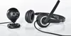 A black webcam and headset are placed on a white surface. Anteprima dell’immagine prodotto