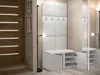 A modern hallway with a white wardrobe and shoe storage unit, a wooden door, and a floor lamp. Náhľad obrázku produktu