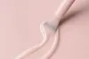 A close-up shot of a nail polish brush applying a light pink polish. Náhľad obrázku produktu