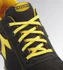 A close-up view of the front of a black and yellow work shoe. Náhľad obrázku produktu