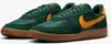 A pair of green Nike Field General sneakers with yellow accents and brown soles, displayed against a white background. Podgląd zdjęcia produktu