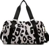 A leopard print duffel bag with black straps and gold hardware, shown against a white background. Produktbild-Vorschau