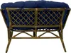 The back view of a rattan sofa with blue cushions. Produktbild-Vorschau