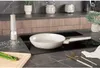 A kitchen counter with cooking utensils and appliances. Voir les images du produit