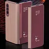 Two folded smartphones with protective cases are displayed against a dark, abstract background with streaks of light. Produktbild-Vorschau