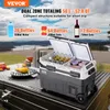 A portable dual-zone cooler is open and filled with drinks, placed on a table outdoors with a scenic view in the background. Produktbild-Vorschau