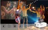 A projector displaying a party scene, with people in the foreground celebrating with sparklers. Produktbild-Vorschau