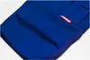 A close-up view of a blue garment, likely pants or shorts, with a red brand tag. Produktbild-Vorschau