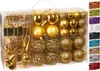 A clear, well-lit product shot of a set of gold Christmas ornaments in a transparent plastic box. Náhled obrázku produktu