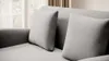 A close-up view of a gray sofa with two pillows. Produktbild-Vorschau