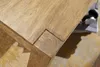 Close-up of a wooden table corner with visible wood grain and joinery. Produktbild-Vorschau