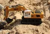 A toy excavator is digging in sand. Náhľad obrázku produktu