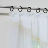A close-up view of white sheer curtains hanging from a metal curtain rod. Produktbild-Vorschau