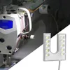 A sewing machine illuminated by a close-up of an LED light. Podgląd zdjęcia produktu