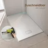 A shower tray in a bathroom setting, with a close-up inset showing a tool being used. Náhľad obrázku produktu