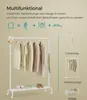 A white garment rack with clothes and shoes on it, presented with diagrams illustrating its multifunctional nature. Produktbild-Vorschau
