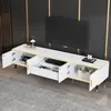 A modern TV stand with a marble-like finish, featuring open compartments and drawers, with a television mounted on the wall behind it. Podgląd zdjęcia produktu