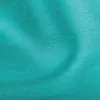 A close-up view of turquoise fabric with visible texture and folds. Voir les images du produit