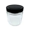 A clear studio shot of a glass jar with a black lid. Produktbild-Vorschau