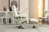 A beige massage chair and ottoman are shown in a well-lit room with a decorative shelf and a floor lamp. Produktbild-Vorschau