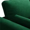 Close-up view of a green velvet armchair, showing the texture of the fabric and the stitching on the armrest. Produktbild-Vorschau