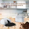 A kitchen counter with coffee filters, activated charcoal, and coffee beans. Produktbild-Vorschau