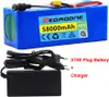 A blue battery pack with a charger and cables. Voir les images du produit
