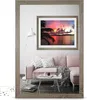 A living room scene with a pink sofa, a coffee table, and a mirror reflecting a tropical sunset. Produktbild-Vorschau