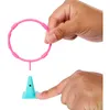 Hands holding a pink ring and a turquoise cone, demonstrating a toy. Produktbild-Vorschau