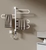 A white electric towel rack with two towels hanging on it, plugged into a white wall outlet. Produktbild-Vorschau