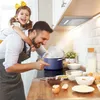 A father and daughter are cooking together in a kitchen. Náhľad obrázku produktu