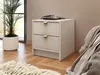 A bedside table with two drawers in a bedroom setting, next to a bed and a potted plant. Produktbild-Vorschau