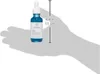 A hand is holding a small blue bottle of serum with a white dropper cap. A ruler graphic with measurements in inches and centimeters is superimposed on the image. Produktbild-Vorschau