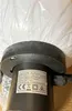 A close-up view of the base of a garden light, showing a label with product information. Produktbild-Vorschau