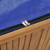 A close-up of a wooden box with a blue cover and two zippers. Anteprima dell’immagine prodotto