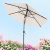 An umbrella is shown against a blue sky with pink flowers in the foreground. Anteprima dell’immagine prodotto