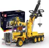 A yellow toy tow truck with a crane is displayed next to its packaging box. Náhľad obrázku produktu